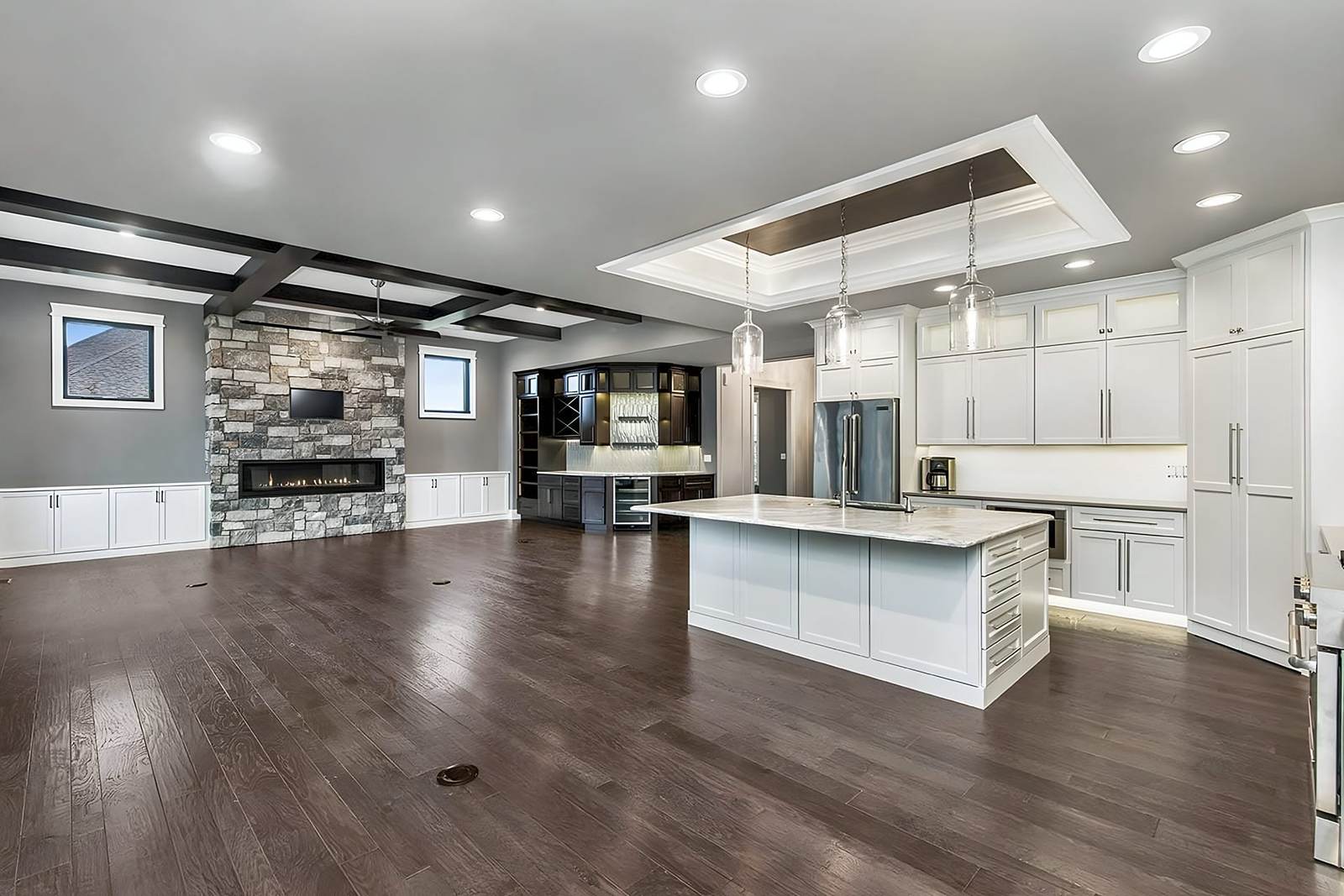 Great room and kitchen with a dark wood floor