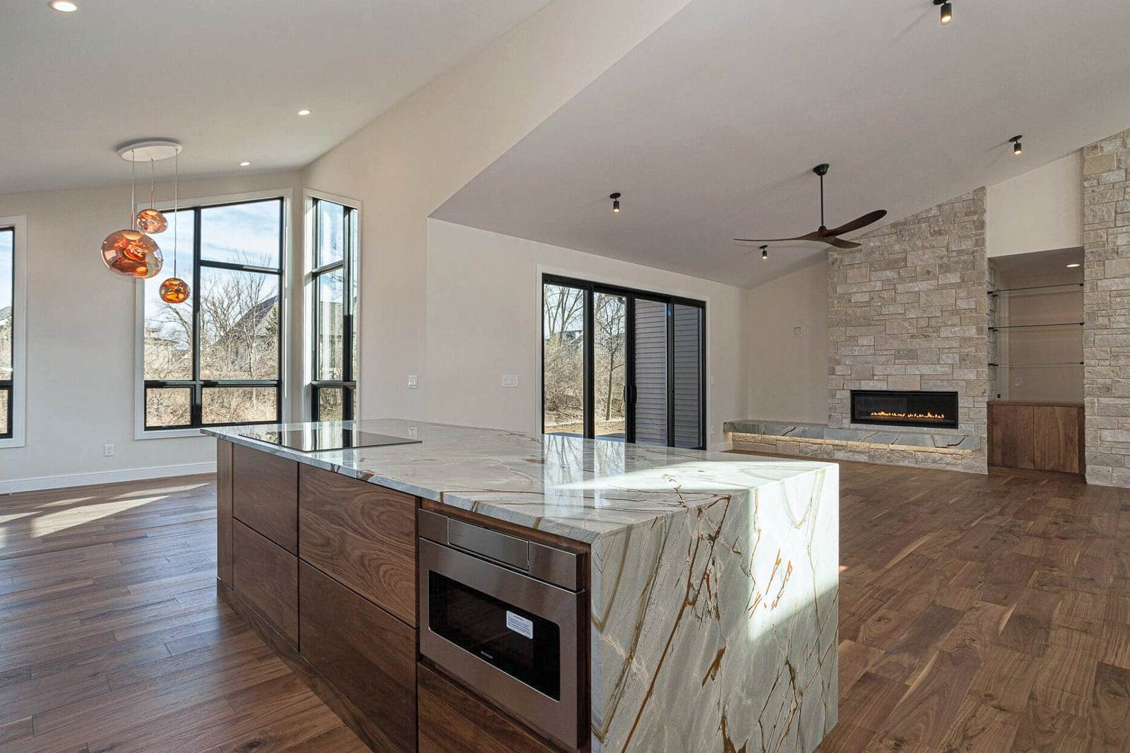 Kitchen with stone island and wood floor