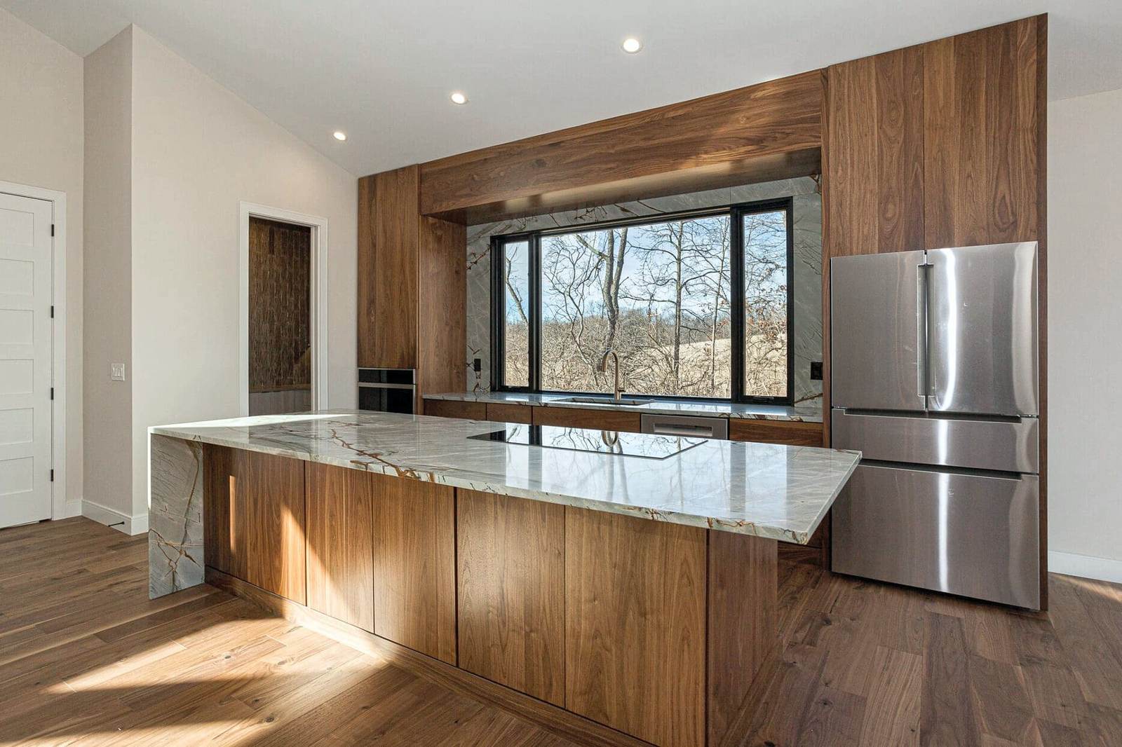 Kitchen with walnut island over a wood floor